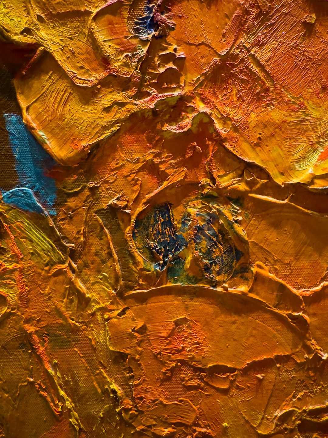 Thick orange and yellow impasto brushstrokes on an oil painting.