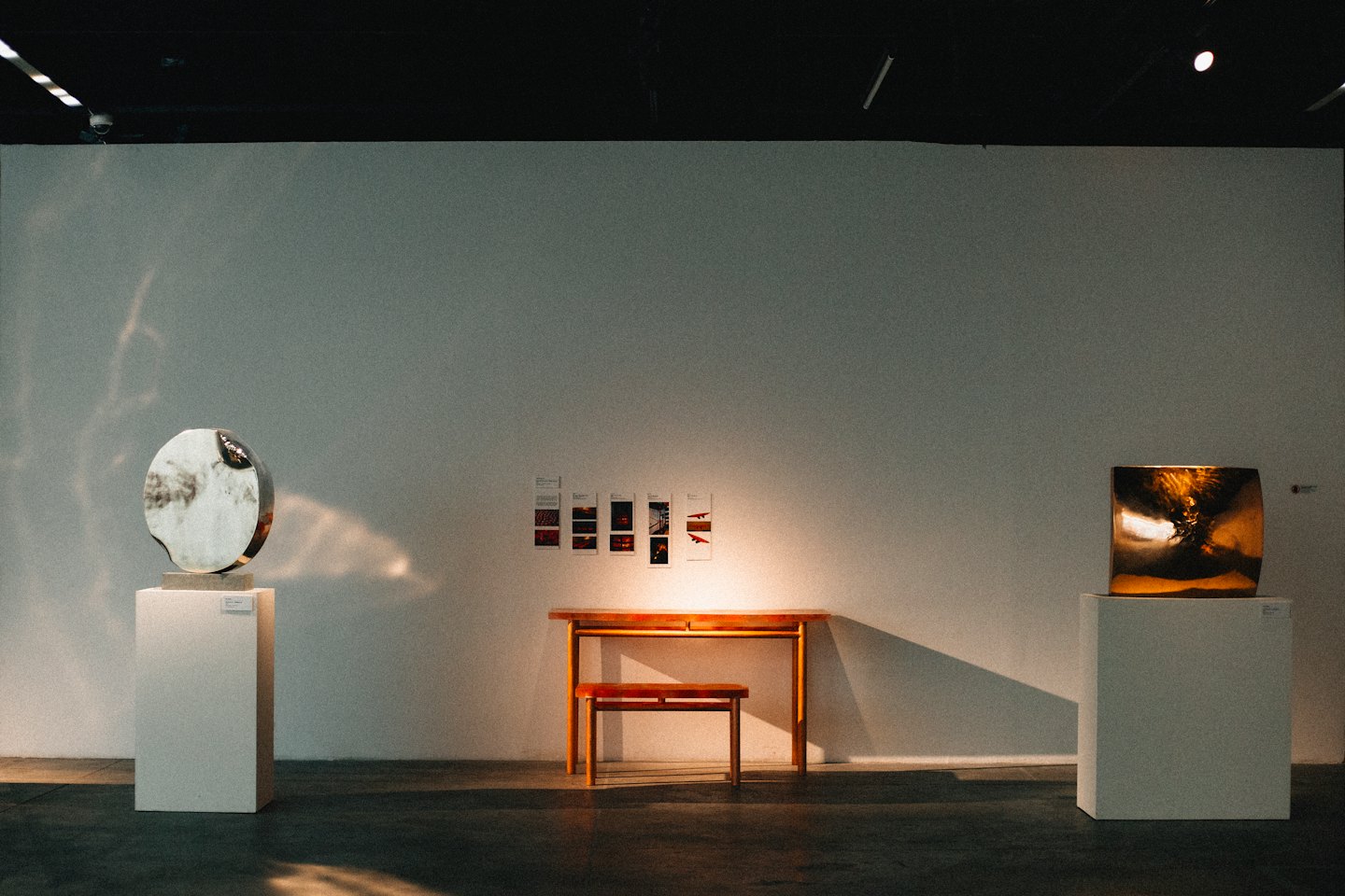 Two abstract sculptures in a minimalist art gallery.